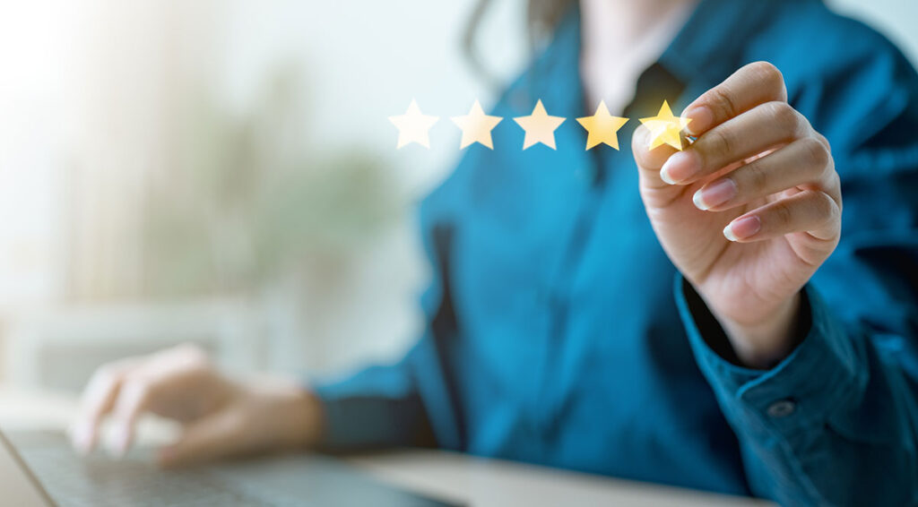woman pressing 5 star buttons